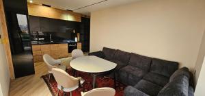 a living room with a couch and a table and chairs at Sayram in Yunusobod