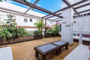 a patio with a bench and some plants at Cadizz-Ático El Falla con terraza de 40m2 in Cádiz