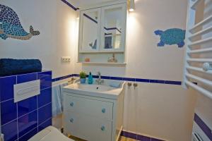 a bathroom with a sink and a toilet at Terraza junto a La Caleta El Faro del Manteca I in Cádiz +24 photos
