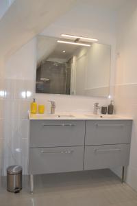 a white bathroom with a sink and a mirror at 3 Chambres pour 2 à 6 pers Paris Ouest B&B in Rueil-Malmaison +4 photos