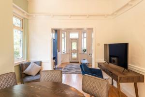 a living room with a table and a tv at Spacious 3BR Home - Comfort & Convenience in Manchester