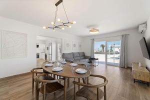 a dining room and living room with a table and chairs at Villa Yaiza Secret 1 in Yaiza