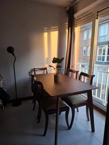 a dining room table with chairs and a potted plant on it at Alojamiento AJO con piscina y tenis - Ajo Palace in Ajo