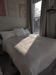 a large bed in a bedroom with a window at Sunny in London