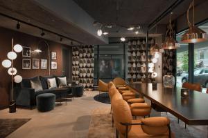 a living room with a long table and chairs at Scandic Sjølyst in Oslo