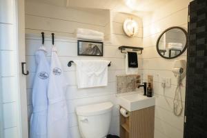 a small bathroom with a toilet and a sink at Cozy Caboose Retreat | Sleeps 4 | Fire Pit in Fredericktown +10 photos