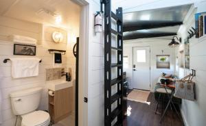 a small bathroom with a toilet and a sink at Cozy Caboose Retreat | Sleeps 4 | Fire Pit in Fredericktown +14 photos