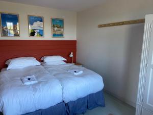 a bedroom with two beds with towels on them at May Isle in Crail