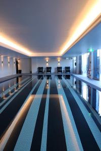 an empty swimming pool with chairs in a building at Ovolo Woolloomooloo in Sydney