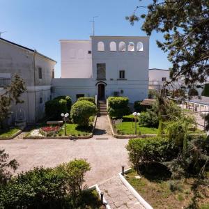 a white building with a pathway leading to it at Tenuta Lo Cuoccio in Gravina in Puglia +68 photos