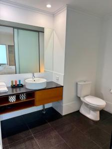 a bathroom with a toilet and a sink and a mirror at HAVEN by the Sea in Mandurah +13 photos