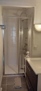 a bathroom with a shower and a sink at Maison de village in Sigean