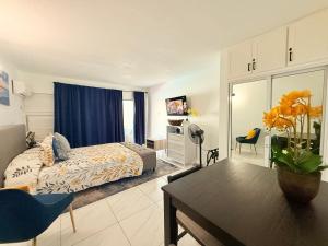 a bedroom with a bed and a table in a room at Beachfront home near Dunns River Falls in Tower Isle