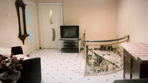 a living room with a crib and a television at muree cottage in Murree