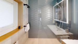 a bathroom with a shower with a glass door at Peaceful Lakefront Living, your Buchillon Retreat! LR23B in Buchillon +18 photos
