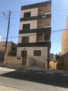 a building on the side of a street at Furnished apartment for rent in Amman Khalda in Amman
