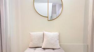 a mirror hanging above a couch with two pillows at Do Campanili by Ca-Sa Check in Chioggia +113 photos