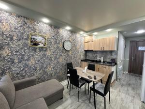 a kitchen and living room with a table and a couch at Beautiful apartments near the sea Adlia street in Batumi