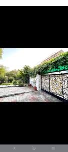 a stone wall with plants on it next to a sidewalk at Drop inn in Islamabad +6 photos