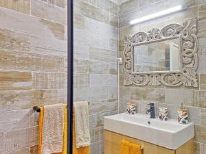 a bathroom with a sink and a mirror at Superbe appartement 2 chambres à Anse Marcel, 400m des plages, activités nautiques incluses - FR-1-734-44 in Anse Marcel  +17 photos