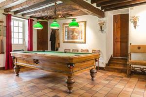 a room with a pool table in a house at Charmant manoir Sud de Paris in Saint-Sauveur-sur-École