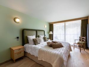 a bedroom with a large bed and a large window at Magnifique appartement 6 pièces avec jacuzzi à Courchevel, proche des pistes - FR-1-562-79 in Courchevel +7 photos