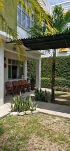 a building with benches in front of a building at Ecopousada Miriti in Belém +88 photos