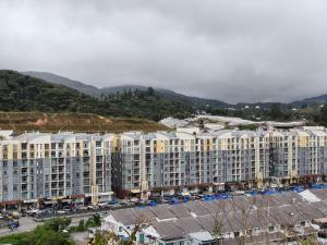 a large apartment building in a city with mountains at Studio BARRINGTON SQUARE II in Brinchang