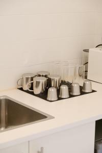a kitchen counter with pots and pans on a stove at Atla Living Athens in Athens