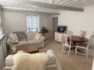 a living room with a couch and a table at Historical Townhouse in Aabenraa