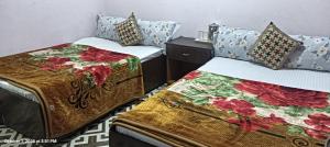 two beds sitting next to each other in a room at SAI Guest House at Gangtok Taxi Stand in Gangtok