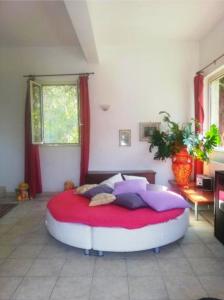 a bedroom with a large red and white bed at Villa GIANNA in Spoltore