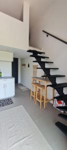 a room with a staircase with a table and chairs at Studio 2 terrasse aperçu mer vignes in Saint-Cyr-sur-Mer