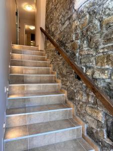 a stone staircase in a home with a stone wall at Studio Apartment Tsar Kaloyan Near Tsarevets in Veliko Tŭrnovo