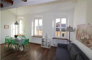 a living room with a couch and a table and chairs at Penthouse in the center of Parma - bookable parking space in Parma