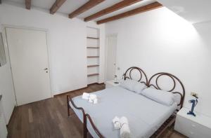 a bedroom with a white bed with white pillows at Penthouse in the center of Parma - bookable parking space in Parma