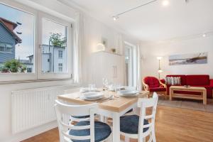a kitchen and dining room with a table and chairs at Villa Sonneck - Apartment 3 in Ostseebad Sellin