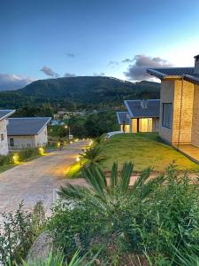 a house with a driveway in front of a house at Pousada Varandas de Minas in Monte Verde