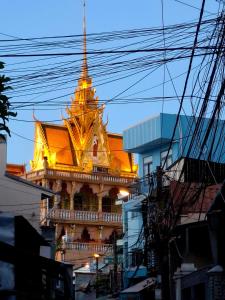 a building with a golden steeple on top of it at Tiny house, traditional, friendly neighbour, center, sunset lake view in Can Tho
