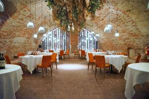 a dining room with tables and chairs and a large window at Hotel San Giovanni Resort in Saluzzo