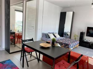 a living room with a table and a couch at Independence Studio in Bucharest