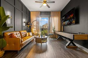 a living room with a couch and a pool table at Lookout Luxe 2BR | Shuffleboard | Classy | 1GB in Dallas