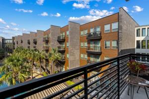 an apartment balcony with palm trees and buildings at Lookout Luxe 2BR | Shuffleboard | Classy | 1GB in Dallas