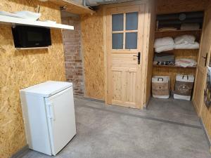 a white refrigerator in a room with a door at Room 1 industrial in Krakow +4 photos