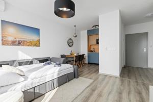 a bedroom with a bed and a dining room at Bratislava Airport Apartment in M R Stefanik