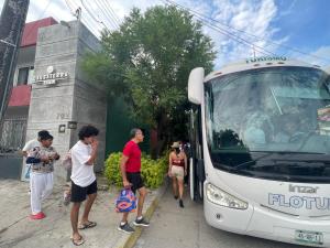 a group of people waiting to get on a bus at Hotel Cassaterra in Ciudad Valles