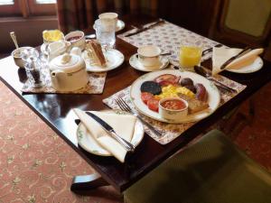 a table with a plate of breakfast food on it at Uphill Manor Bed & Breakfast in Uphill