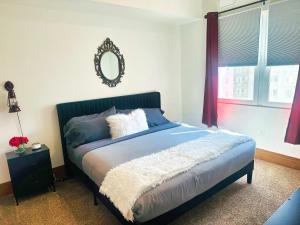 a bedroom with a bed with a mirror on the wall at 3BR King Bed Chamber Apartment at The Grand Castle in Grandville