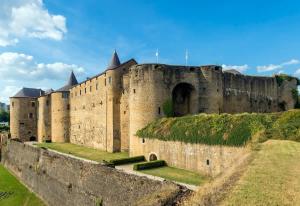 a large castle with grass on top of it at Budget Studio avec Parking in Charleville-Mézières