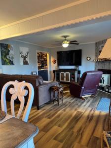 a living room with a couch and a table at Beech Mountain Getaway in Beech Mountain